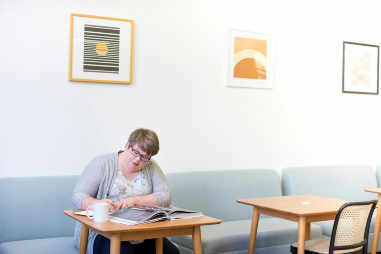 Student working on budget analysis with mentor guidance