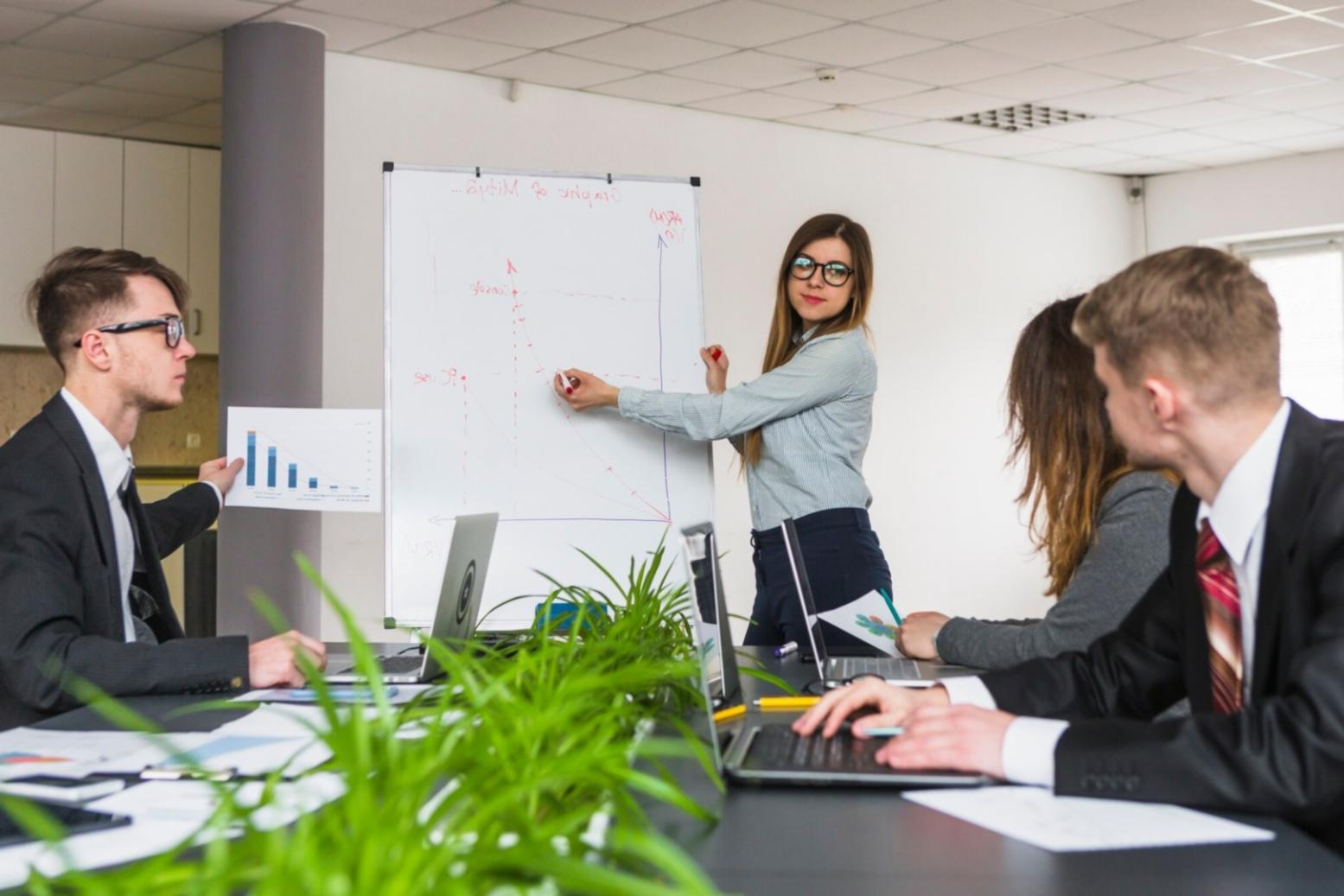 Students practicing annual budget planning techniques in classroom setting